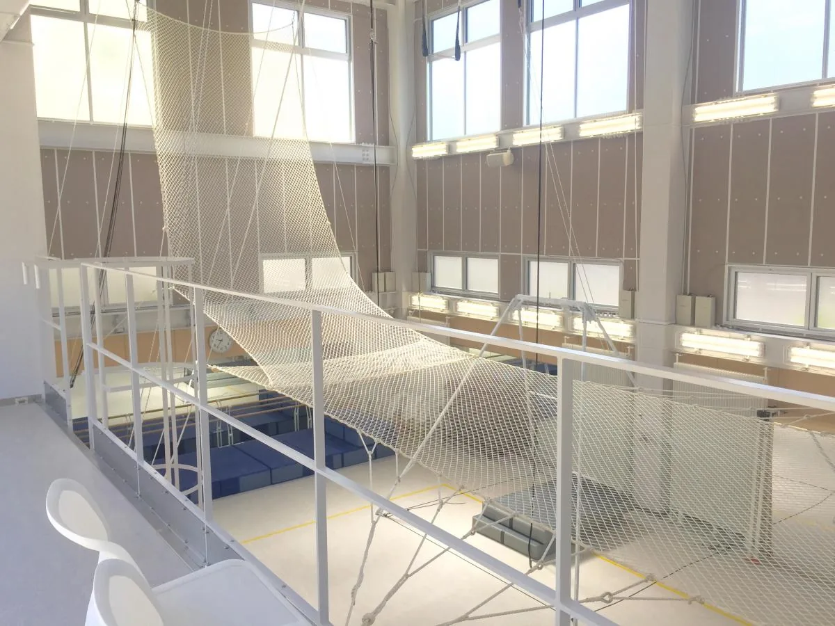 Indoor flying trapeze rig and net inside a purpose-built hall — Fly n Fit, Nagoya, Japan — MACA flying trapeze rig