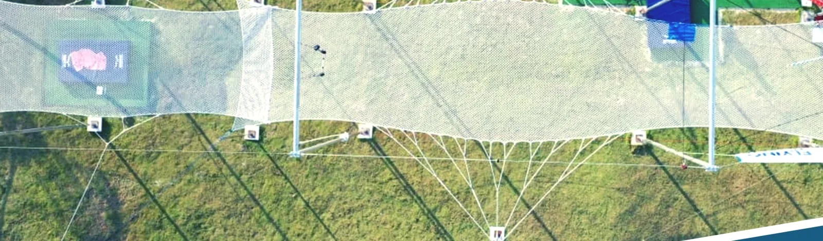 Aerial overhead view of a full-size flying trapeze rig and net — MACA flying trapeze rig